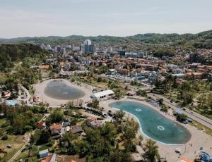 an aerial view of a city with two large ponds at D Mol Studio apartman in Tuzla
