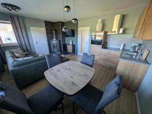 a kitchen and living room with a table and chairs at Dümmerblick II in Hüde