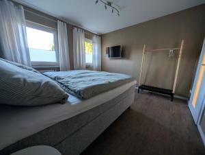 a bedroom with a bed and a window at Dümmerblick II in Hüde