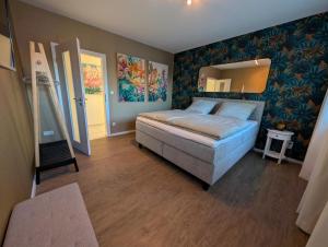 a bedroom with a bed and a mirror on the wall at Dümmerblick II in Hüde