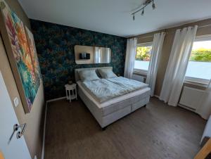 a small bedroom with a bed and a window at Dümmerblick II in Hüde