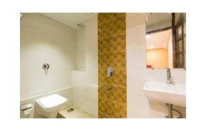 a bathroom with a toilet and a sink at Near Beach HOTEL - VERSOVA INN in Jāmb