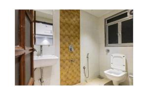 a bathroom with a toilet and a sink at Near Beach HOTEL - VERSOVA INN in Jāmb +9 photos