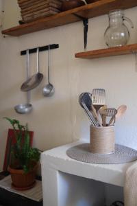 a kitchen counter with utensils on top of it at Tilcara Mistica Hostel in Tilcara