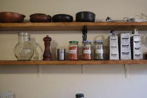 a shelf with jars and other items on it at Tilcara Mistica Hostel in Tilcara +21 photos
