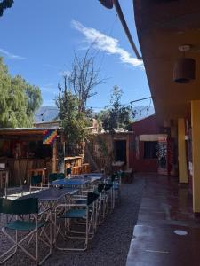 a group of tables and chairs sitting outside of a building at Tilcara Mistica Hostel in Tilcara