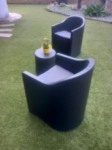 two chairs sitting on the grass in a yard at Baby Home in Dalmine