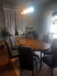 a dining room with a wooden table and chairs at Baby Home in Dalmine +6 photos