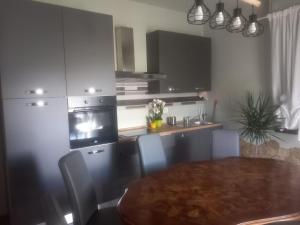 a kitchen with a table and a kitchen with a stove and a microwave at Baby Home in Dalmine