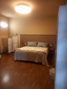 a bedroom with a large bed with a wooden floor at Baby Home in Dalmine
