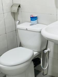 a bathroom with a white toilet and a sink at lagoon holiday villa Jaffna in Tavadi +27 photos
