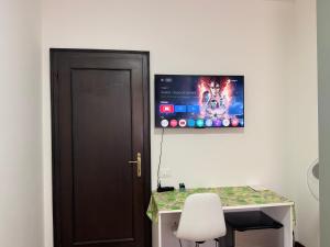 a room with a desk with a monitor on the wall at First Dream Mestre in Mestre