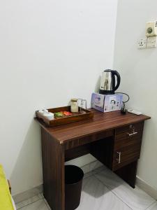 a wooden desk with a coffee maker on top of it at lagoon holiday villa Jaffna in Tavadi