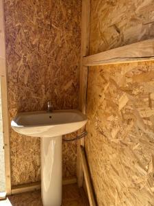 a bathroom with a sink and a stone wall at Azamat Nomad Camp in Song-Kul +101 photos
