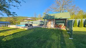 a backyard with a pool and a house at Green Oasis Apartment in Sarajevo