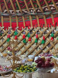 a table with a bunch of food on it at Azamat Nomad Camp in Song-Kul