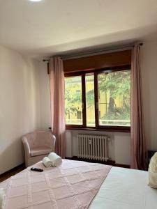a bedroom with a bed and a window and a chair at First Dream Mestre in Mestre