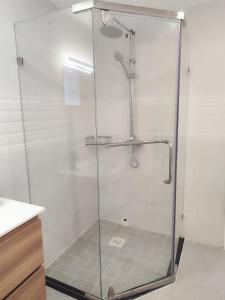 a shower with a glass door in a bathroom at Sweet Haven - Sports Rd in Westlands +16 photos