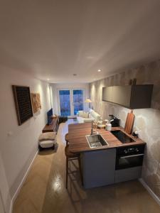a kitchen and living room with a sink and a couch at Riekje in Lage Zwaluwe