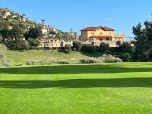 a house on top of a lush green field at Il Colle in Sanremo