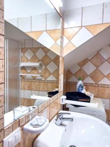 a bathroom with a sink and a mirror at La Ginestra - Casa Vacanze in Porto Alabe +24 photos