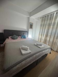 a bedroom with a large bed with two towels on it at Ohrid Demarko Apartment in Ohrid +21 photos