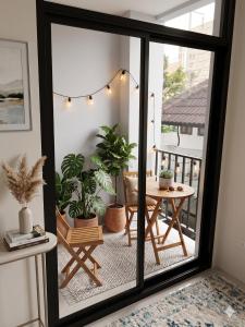 a balcony with a table and potted plants at Chaba CBP Chiang Mai in Chiang Mai