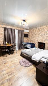a bedroom with a bed and a brick wall at Panorama Gora in Kutaisi +26 photos