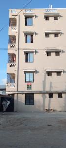 a building with a dog laying in front of it at COZY Two BEDROOM in Bamburi