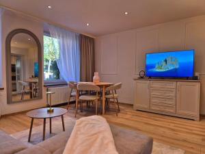 a living room with a television and a table at DORMAR I Apartament in Wałbrzych