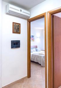 a door leading to a bedroom with a bed at La Ginestra - Casa Vacanze in Porto Alabe
