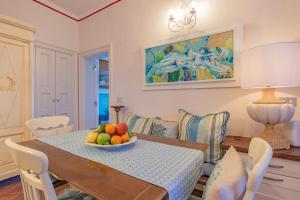 a dining room with a table with a bowl of fruit on it at Apartament Vista capomare in Capoliveri
