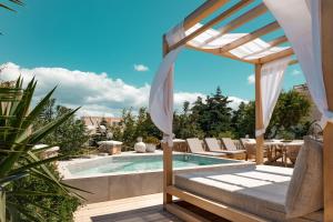 a pool with a gazebo next to a patio at Selenophile Villa with heated pool in Monolithos