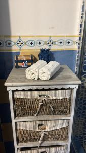 a shelf with towels and towels on top at Casa Ada - Incantevole loft in centro in Lampedusa