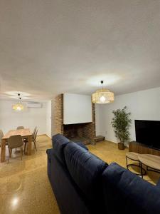 a living room with a couch and a table at El refugio de NaRo in Chella
