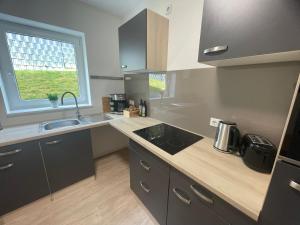 a kitchen with a counter and a sink and a window at Ferienwohnung Moor in Wickede (Ruhr)