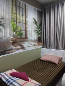 a bed with two pillows on it in a bedroom at Sleep cafe hidee247 in Pratunam