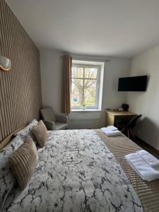 a bedroom with a large bed and a window at Vievija Hotel in Vievis