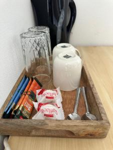 a wooden tray with utensils and a container of food at Vievija Hotel in Vievis