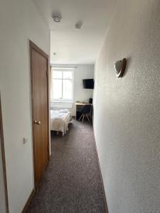 a room with a bedroom with a bed and a door at Vievija Hotel in Vievis +2 photos
