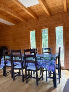 a dining room with a table and chairs at Hargitaház Mountain House in Harghita-Băi
