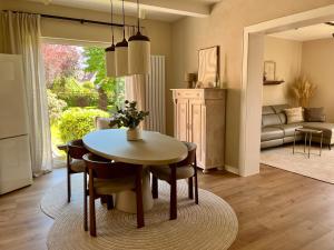 a living room with a table and chairs and a couch at LIV Apartments in Stadthagen