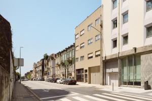 an empty city street with buildings and cars parked at Home on Rua da Alegria in Bicas