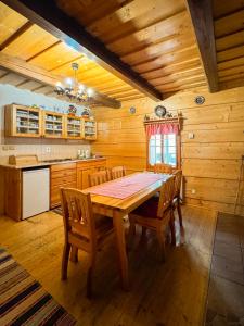 a dining room with a wooden table and chairs at Drevenica u Starona in Liptovská Kokava