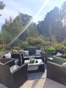 a patio with couches and a table and a umbrella at FewoSaric Apartment Marlon in Vir