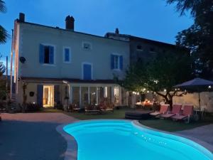 a villa with a swimming pool in front of a house at Maison des Ingénieurs in Molières-sur-Cèze
