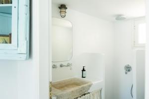 a bathroom with a sink and a mirror at Thavma Kalosyni in Firopótamos +9 photos