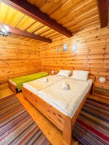 a bedroom with a bed in a wooden room at Drevenica u Starona in Liptovská Kokava
