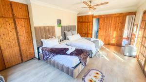 a bedroom with two beds and a ceiling fan at Foodong Accommodation in Worcester