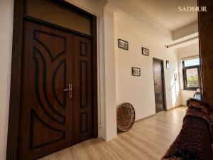 a room with a wooden door and a hallway at Family Guest House SadNur in Bukhara +71 photos